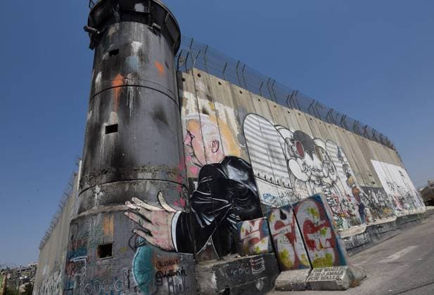 Graffiti of U.S. President Donald Trump is seen on Israel s controversial separation wall in the biblical city of Bethlehem, West Bank, August 9, 2017. The graffiti depicts Trump with hearts, hugging the Israeli army watchtower in the wall. -  JER2017080903 DEBBIExHILL