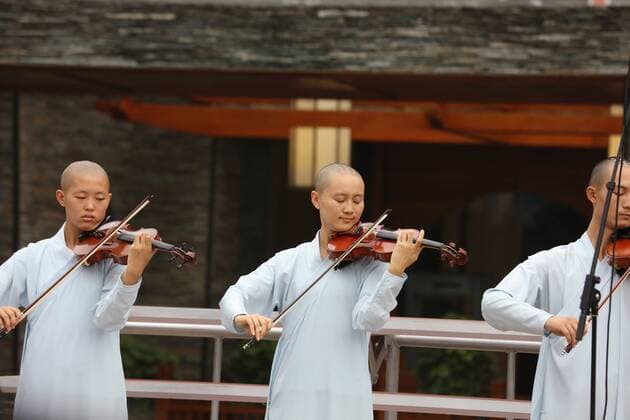 ZHANGJIAJIE, CHINA - AUGUST 21: China s first monks chorus, Dawn chorus from Tiantai Temple Conservatory of Buddhist Music, perform on the roof of a music hall at the 2017 Huanglong Music Festival and International Chorus Week on August 21, 2017 in Zhangjiajie, Hunan Province of China. 112 teams will compete in the 2017 Huanglong Music Festival and International Chorus Week held in Zhangjiajie.  Copyright: xVCGx CFP111123804632