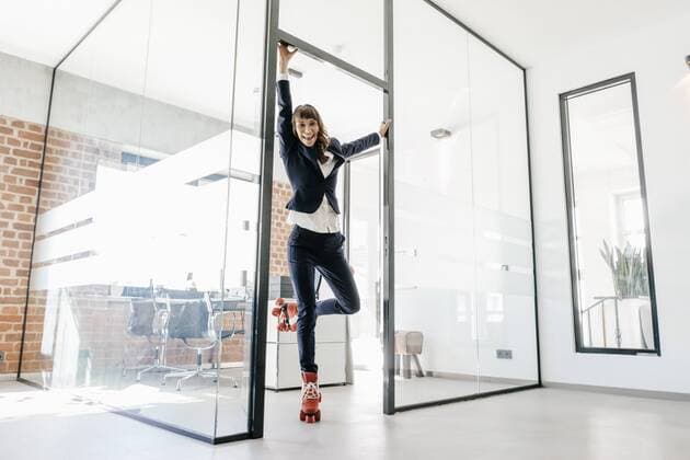 Successful businesswoman wearing roller skates in office model released Symbolfoto property released  KNSF02092