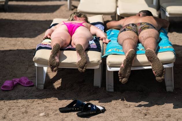 KEMER, TURKEY - AUGUST 22, 2017: Tourists sunbathing on a beach on the Mediterranean Sea coast. Sergei Bobylev TASS  TS05D364