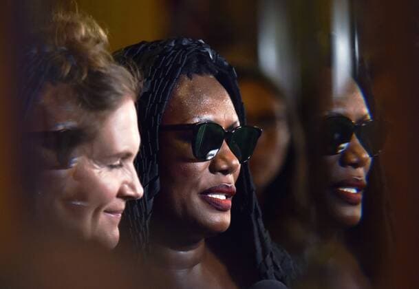 Grace Jones (R) and director Sophie Fiennes are reflected in the glass entry doors of the Elgin Theatre as they arrive for the world premiere of the documentary Grace Jones: Bloodlight and Bami on opening night of the 42nd Toronto International Film Festival in Toronto, Canada on September 7, 2017.  TOR2017090709 CHRISTINExCHEW