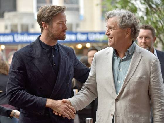 Actor Armie Hammer (L) and co-founder of Sony Pictures Classics Tom Bernard shake hands as they arrive at the premiere of Call Me By Your Name on opening night of the 42nd Toronto International Film Festival at Ryerson Theatre in Toronto, Canada on September 7, 2017.  TOR2017090734 CHRISTINExCHEW