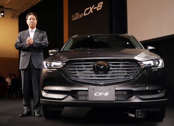 September 14, 2017, Tokyo, Japan - Japan s automaker Mazda president Masamichi Kogai displays the new sports utility vehicle (SUV) CX-8 in Tokyo on Thursday, September 14, 2017. The new crossover SUV has a turbo charged 2.2-litre diesel engine to drive three-row seats roomy body.  (lwxa013589)