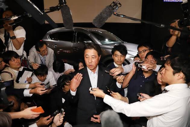 September 14, 2017, Tokyo, Japan - Japan s automaker Mazda president Masamichi Kogai is surrounded by reporters after he introduced the new sports utility vehicle (SUV) CX-8 in Tokyo on Thursday, September 14, 2017. The new crossover SUV has a turbo charged 2.2-litre diesel engine to drive three-row seats roomy body.  (lwxa013594)