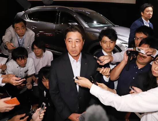 September 14, 2017, Tokyo, Japan - Japan s automaker Mazda president Masamichi Kogai is surrounded by reporters after he introduced the new sports utility vehicle (SUV) CX-8 in Tokyo on Thursday, September 14, 2017. The new crossover SUV has a turbo charged 2.2-litre diesel engine to drive three-row seats roomy body.  (lwxa013599)