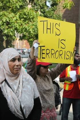 September 16, 2017 - Toronto, ONTARIO, Canada - Protestor holds a sign saying This is Terrorism as hundreds of demonstrators marched to protest against the violence against Rohingyas in Myanmar, in Toronto, Canada on September 16, 2017. Protestors called for Canada to pressure the United Nations to urge the government of Myanmar to stop the violence against Rohingya Muslims and allow Canada to investigate into the claims of genocide. Nearly 400,000 Rohingya refugees have fled into Bangladesh since late August during the outbreak of violence in the Rakhine state in Myanmar. The United Nations has called the longstanding crisis in Buddhist-majority Myanmar a textbook example of ethnic cleansing. Toronto Canada  - ZUMAn230 20170916_zaa_n230_936 Copyright: xCreativexTouchxImagingxLtdx