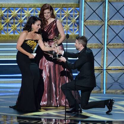 Actor Julia Louis-Dreyfus accepts the award for Outstanding Lead Actress in a Comedy Series for Veep from actor Debra Messing and TV personality Chris Hardwick onstage during the 69th Annual Primetime Emmy Awards at Microsoft Theater on September 17, 2017 in Los Angeles, California.  LAP201709172000 JIMxRUYMEN