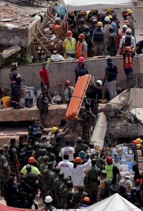 (170921) -- MEXICO CITY, Sept. 21, 2017 -- Rescuers and members of Mexican Army search for survivors at the Enrique Rebsamen school after an earthquake in Mexico City, capital of Mexico, on Sept. 20, 2017. Elements from the civil protection corps, Red Cross, army, police and voluntary civilians worked through the day on Wednesday to remove rubble from collapsed buildings in Mexico City, after the magnitude-7.1 earthquake shook the center of the country on Tuesday. ) (ma) (vf) (hy) MEXICO-MEXICO CITY-ENVIRONMENT-EARTHQUAKE MONTSERRATxLOPEZ 