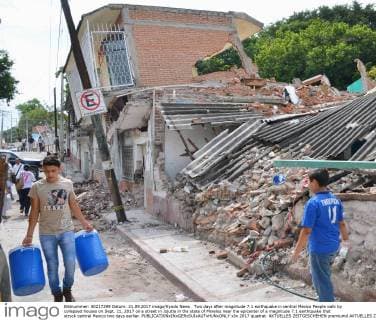 Two days after magnitude 7.1 earthquake in central Mexico People walk by collapsed houses on Sept. 21, 2017 on a street in Jojutla in the state of Morelos near the epicenter of a magnitude 7.1 earthquake that struck central Mexico two days earlier. 