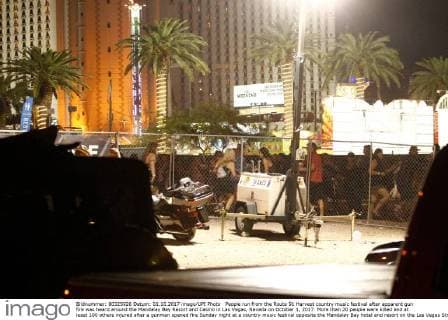 People run from the Route 91 Harvest country music festival after apparent gun fire was heard around the Mandalay Bay Resort and Casino in Las Vegas, Nevada on October 1, 2017. More than 20 people were killed and at least 100 others injured after a gunman opened fire Sunday night at a country music festival opposite the Mandalay Bay hotel and resort on the Las Vegas Strip, authorities said.  LAV2017100203 JAMESxATOA