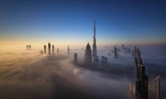 View of the Burj Khalifa and other skyscrapers above the clouds in Dubai, United Arab Emirates. View of the Burj Khalifa and other skyscrapers above the clouds in Dubai, United Arab Emirates.  34315