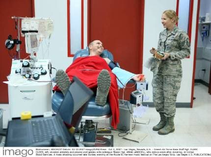 Oct 2, 2017 - Las Vegas, Nevada, U.S. - Creech Air Force Base Staff Sgt. CLARK OLSEN, left, donates platelets and plasma and speaks with colleague Master Sgt. ANNA LANSDELL, who eats a snack after donating, at United Blood Services. A mass shooting occurred late Sunday evening at the Route 91 Harvest music festival on The Las Vegas Strip. Las Vegas U.S.  - ZUMA 20171002_mda_c98_019 Copyright: xRondaxChurchillx