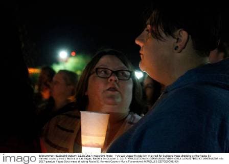 Two Las Vegas friends join in a vigil for Sundays mass shooting at the Route 91 Harvest country music festival in Las Vegas, Nevada on October 2, 2017.  LAV2017100243 JAMESxATOA