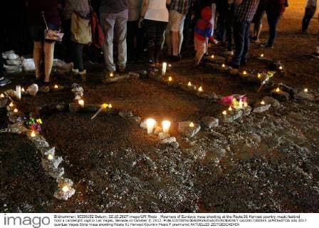 Mourners of Sundays mass shooting at the Route 91 Harvest country music festival hold a candelight vigil in Las Vegas, Nevada on October 2, 2017.  LAV2017100245 JAMESxATOA