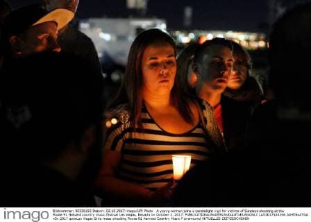 A young woman joins a candlelight vigil for victims of Sundays shooting at the Route 91 Harvest country music festival Las Vegas, Nevada on October 2, 2017.  LAV2017100246 JAMESxATOA