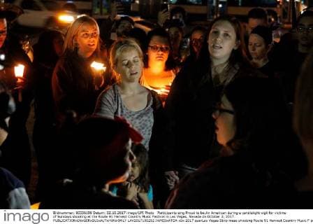Participants sing Proud to be An American during a candlelight vigil for victims of Sundays shooting at the Route 91 Harvest Country Music Festival in Las Vegas, Nevada on October 2, 2017.  LAV2017100252 JAMESxATOA