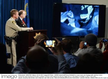 LVMPD Undersheriff Kevin McMahill (L) views body cam footage with reporters taken during the mass shooting at Sunday s outdoor country music festival on the Las Vegas Strip in Las Vegas on October 3, 2017. Fifty-nine people, including the shooter were killed and over 500 injured.  LAV20171003812 JIMxRUYMEN