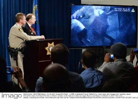 LVMPD Undersheriff Kevin McMahill (L) views body cam footage with reporters taken during the mass shooting at Sunday s outdoor country music festival on the Las Vegas Strip in Las Vegas on October 3, 2017. Fifty-nine people, including the shooter were killed and over 500 injured.  LAV20171003814 JIMxRUYMEN