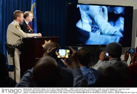 LVMPD Undersheriff Kevin McMahill (L) views body cam footage with reporters taken during the mass shooting at Sunday s outdoor country music festival on the Las Vegas Strip in Las Vegas on October 3, 2017. Fifty-nine people, including the shooter were killed and over 500 injured.  LAV20171003813 JIMxRUYMEN