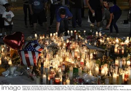 Oct 3,2017. Las Vegas NV. People gather at a candle light vigil on Sahara and Las Vegas Blvd. to remember the shooting victims Tuesday night. The latest on victims as of Tuesday is still 59 dead, 527 injured with only 3 victims left to be identified by family members of those who were killed. The shooting happen during day 3 of the Route 91 Harvest Festival.. Photo by ZumaPress. Las Vegas U.S. - ZUMAbl1_ 20171003_zaf_bl1_049 Copyright: xGenexBlevinsx