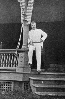 Full length portrait of Governor Theodore Roosevelt, dressed in white, at the top of the steps to his home, Oyster Bay, New York, 1900. 1023_05_65236final