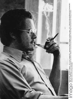 Cartoonist Patrick Oliphant smoking a pipe, 1975. 1023_05_72955final