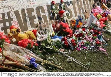 A memorial for the slain victims of the Route 91 Harvest music festival mass shooting is shown near the historic Welcome to Las Vegas sign October 19, 2017, in Las Vegas. A gunman opened fire on the music, leaving 58 dead and over 500 injured on October 1.  LAV20171019005 RONDAxCHURCHILL