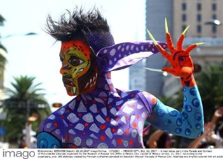 (171022) -- MEXICO CITY, Oct. 22, 2017 -- A man takes part in the Parade and Contest of Monumental Alebrijes organized by the Museum of Popular Art (MPA) in Mexico City, capital of Mexico, on Oct. 21, 2017. According to the organizers, over 180 alebrijes created by Mexican craftsmen paraded on Saturday through the eets of Mexico City. Alebrijes are brightly colored folk art sculptures of fantastical creature. ) (da) (fnc) MEXICO-MEXICO CITY-CULTURAL EVENT STR 