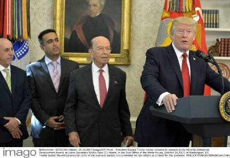 President Donald Trump makes remarks to winners of the Minority Enterprise Development Award, as Labor Secretary Wilbur Ross (C) listens, in the Oval Office of the White House, October 24,2017, in Washington, DC. Trump lauded the entrepreneurial spirit of the business leaders and promoted his tax reform as a boost for the economy.  WAP20171024502 MIKExTHEILER