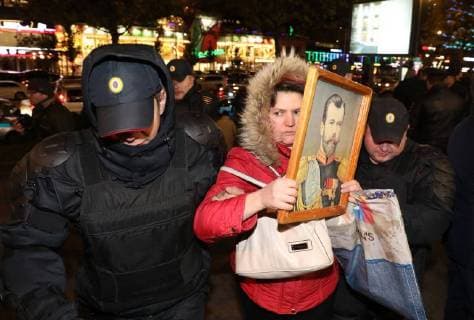 MOSCOW, RUSSIA - OCTOBER 24, 2017: Police officers by a woman protesting outside the Karo 11 Oktyabr cinema ahead of the premiere of Alexei Uchitel s latest film Matilda. Mikhail Pochuyev TASS  TS066613