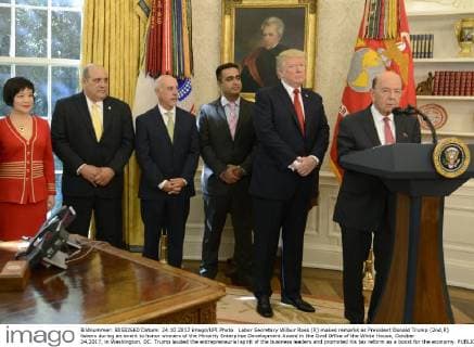 Labor Secretary Wilbur Ross (R) makes remarks as President Donald Trump (2nd,R) listens during an event to honor winners of the Minority Enterprise Development Award in the Oval Office of the White House, October 24,2017, in Washington, DC. Trump lauded the entrepreneurial spirit of the business leaders and promoted his tax reform as a boost for the economy.  WAP20171024506 MIKExTHEILER