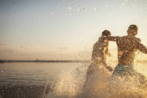 Two friends running in water model released Symbolfoto  VPIF00015