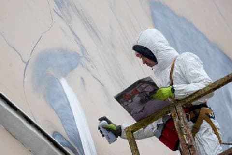 MOSCOW, RUSSIA - OCTOBER 28, 2017: An artist paints a graffiti on a wall in Moscow s Zatsepsky Val Street ahead of the 2018 FIFA World Cup. Sergei Bobylev TASS  TS066E7C