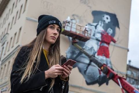 MOSCOW, RUSSIA - OCTOBER 28, 2017: A girl seen by a wall in Moscow s Zatsepsky Val Street where artist paint a graffiti ahead of the 2018 FIFA World Cup. Sergei Bobylev TASS  TS066E7F
