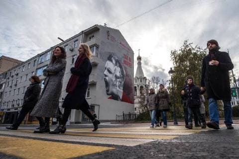 MOSCOW, RUSSIA - OCTOBER 28, 2017: People walk by a graffiti on a wall in Moscow s Nikitsky Boulevard ahead of the 2018 FIFA World Cup. Sergei Bobylev TASS  TS066E87