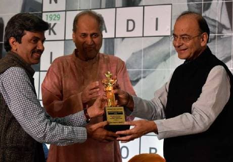 MUMBAI, INDIA - OCTOBER 28: Finance Minister and Minister of Corporate Affairs Arun Jaitley with Chairman and Board of Trustees Rahul Bajaj facilitates Yogesh Jain, secretary of Jan Swasthya Sahyog during the 40th Jamnalal Bajaj Foundation Awards at The Taj Mahal Palace Hotel, on October 28, 2017 in Mumbai, India. Every year, these awards of the Foundation are given to honor and encourage the unprecedented contributions of individuals towards the upliftment and development of the society, rural community and the nation, at large. (Photo by Kunal Patil Hindustan Times ) Finance Minister Arun Jaitley Attends 40th Jamnalal Bajaj Foundation Awards