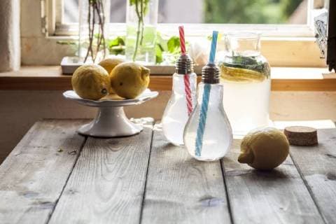 Homemade lemonade with mint on wooden table in front of window  SBDF03298