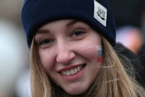 MOSCOW, RUSSIA - NOVEMBER 4, 2017: A girl with the Russian flag painted on her cheek seen outside Moscow s Luzhniki Stadium ahead of a concert titled Russia Unites! marking Russia s National Unity Day. Sergei Bobylev TASS  TS067C91