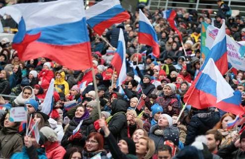 MOSCOW, RUSSIA - NOVEMBER 4, 2017: People wave the Russian flags ahead of a concert titled Russia Unites! marking Russia s National Unity Day at Moscow s Luzhniki Stadium. Sergei Bobylev TASS  TS067CF3