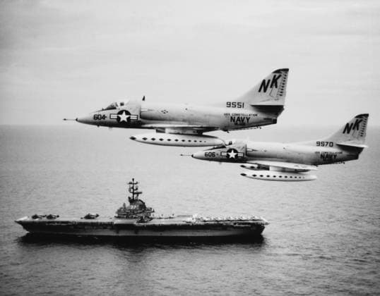 August 12, 1964 - Two Douglas A-4C Skyhawk aircraft fly past anti-submarine aircraft carrier USS Kearsarge (CVS-33) in the Western Pacific. These planes took part in the August 1964 strikes against North Vietnamese PT-boat bases as a result of the Tonkin Gulf Incident.  Copyright: StocktrekxImages STK500661A