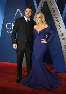 NHL player Mike Fisher and singer-songwriter Carrie Underwood walk the red carpet as they arrive for the 51st Annual Country Music Association Awards on November 8, 2017 at the Bridgestone Arena in Nashville.  NAS20171108162 JOHNxSOMMERSxII