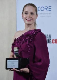 Actress Amy Adams holds the American Cinematheque Award during a photo-op at the entertainment industries annual gala at the Beverly Hilton Hotel in Beverly Hills, California on November 10, 2017. Adams was honored as an extraordinary artist in the entertainment industry currently making a significant contribution to the art of the moving picture.  LAP2017111002 JIMxRUYMEN