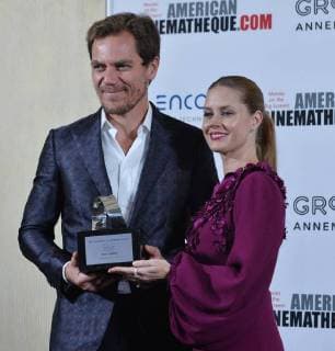 Actress Amy Adams is presented the American Cinematheque Award by actor Michael Shannon during a photo-op at the entertainment industries annual gala at the Beverly Hilton Hotel in Beverly Hills, California on November 10, 2017. Adams was honored as an extraordinary artist in the entertainment industry currently making a significant contribution to the art of the moving picture.  LAP2017111004 JIMxRUYMEN