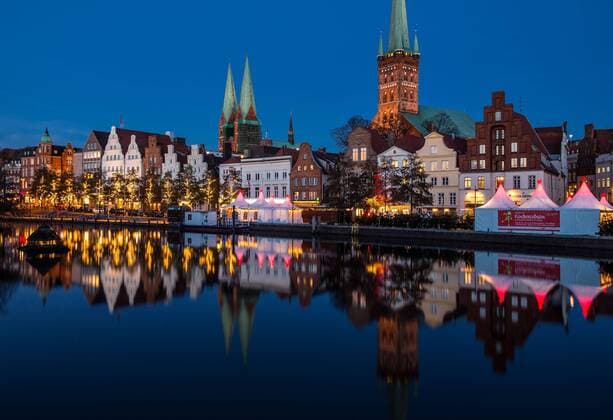 Luebeck Christmas market Lights Lamps at 24 11 2016 on the Christmas Wonderland to the Obertrave in Luebeck in Background is the St Marien Church l and the St Petri Church to see Luebeck Schleswig Holstein Germany