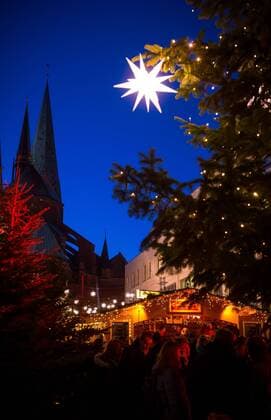 Luebeck Christmas market illuminated Christmas stars hang at 02 12 2016 on the Christmas market on the in Luebeck in Background is the Dom to Luebeck to see Luebeck Schleswig Holstein Germany