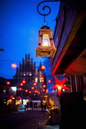 Luebeck Christmas market illuminated Christmas stars hang at 02 12 2016 on the Christmas market behind the Luebeck City Hall in Luebeck Luebeck Schleswig Holstein Germany