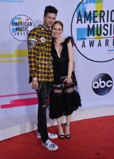 Travis Mills (L) and Madelaine Petsch arrive for the annual American Music Awards held at Microsoft Theater in Los Angeles, on November 19, 2017.  LAP20171119134 JIMxRUYMEN