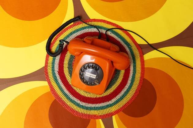 Phone Model realase AVAILABLE ger Old Phone with Dial on Color Surface