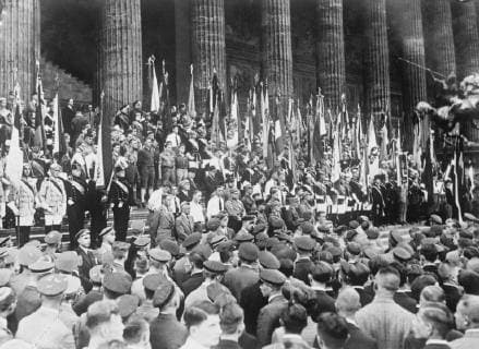 Demonstration against the Versailles treaty in Berlin . On the thirteenth anniversary of the Versailles Treaty coming into effect , a great demonstration took place in the Berlin Lustgarten , when thousands of students gathered to protest against the treaty . Some of the students with their flags at the demonstration . 29 June 1932, Germany Copyright: Topfoto  UnitedArchivesEU032665