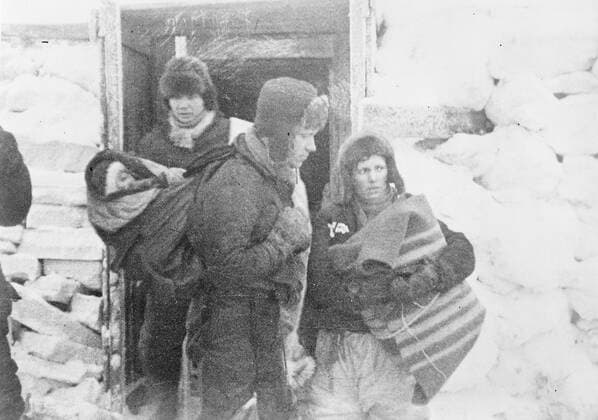 SS Chelyuskin , a Soviet steamship sent out on an expedition to navigate through polar ice along the Northern Maritime Route from Murmansk to Vladivostok , has became ice-bound in Arctic waters during navigation . It was caught in the ice fields in September. After that it drifted in the ice pack before sinking on February 13 , 1934, crushed by the icepacks near Kolyuchin Island in the Chukchi Sea . The crew managed to escape onto the ice and built a makeshift airstrip using only a few spades , ice shovels and two crowbars , which helped in the rescue of the crew . Fifty three men walked over the ice with stores on husky sleds . Photo shows ; The Buiko family leaving for the airfield . 24 March 1934, Russia Federation Copyright: Topfoto  UnitedArchivesEU038087